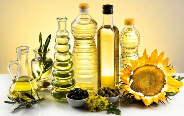 sunflower oil, olives and other ingredients are arranged on a table