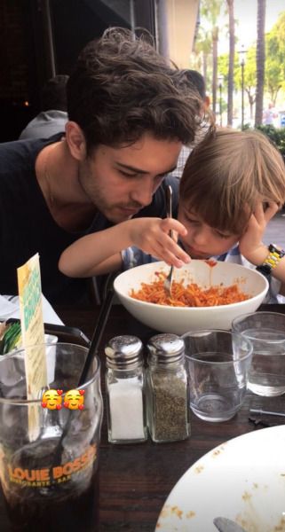 a man and child eating food at a table