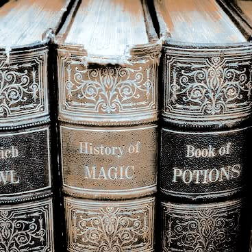 an old book is stacked on top of each other with the words history of magic written on it