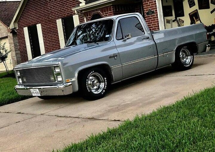 a gray truck parked in front of a house