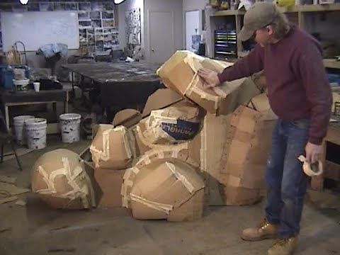 a man standing next to stacks of cardboard boxes