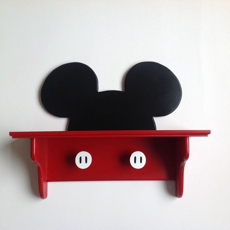 a mickey mouse head is on top of a shelf