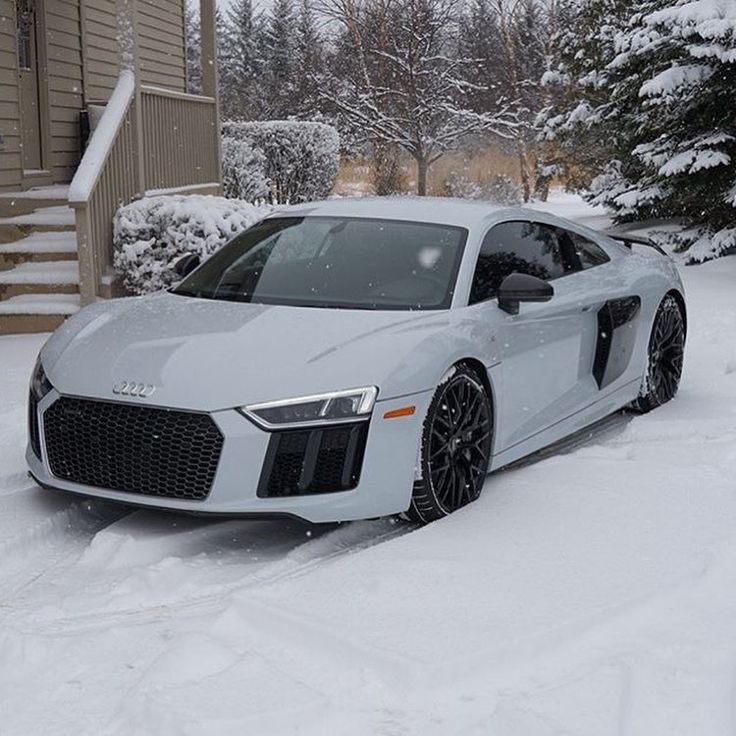 a white car is parked in the snow