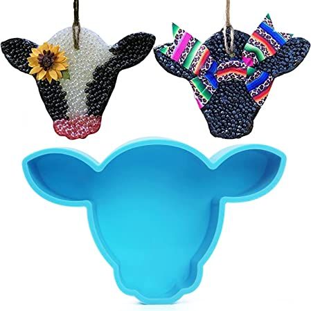 two cow head shaped cookie cutters with sunflower decorations hanging from the top and bottom