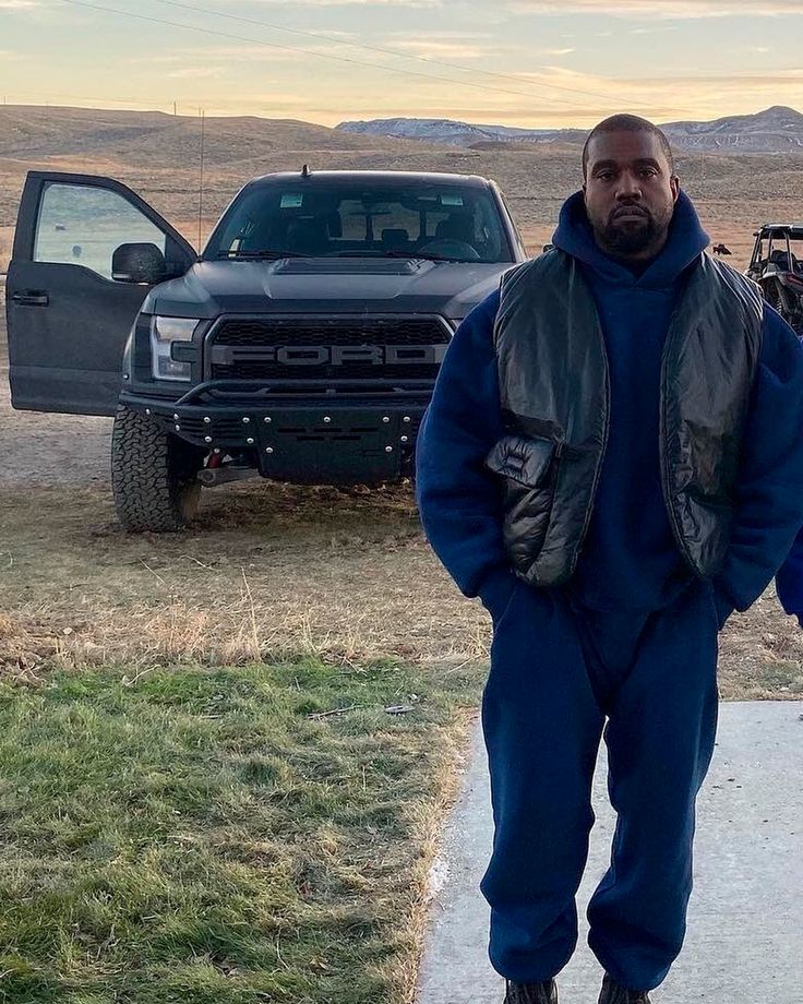 a man standing on the sidewalk next to a truck