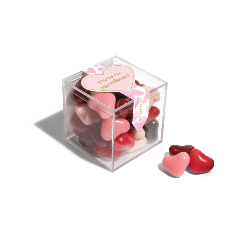 a clear box filled with lots of heart shaped candies