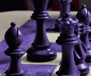 purple chess pieces on a white table cloth