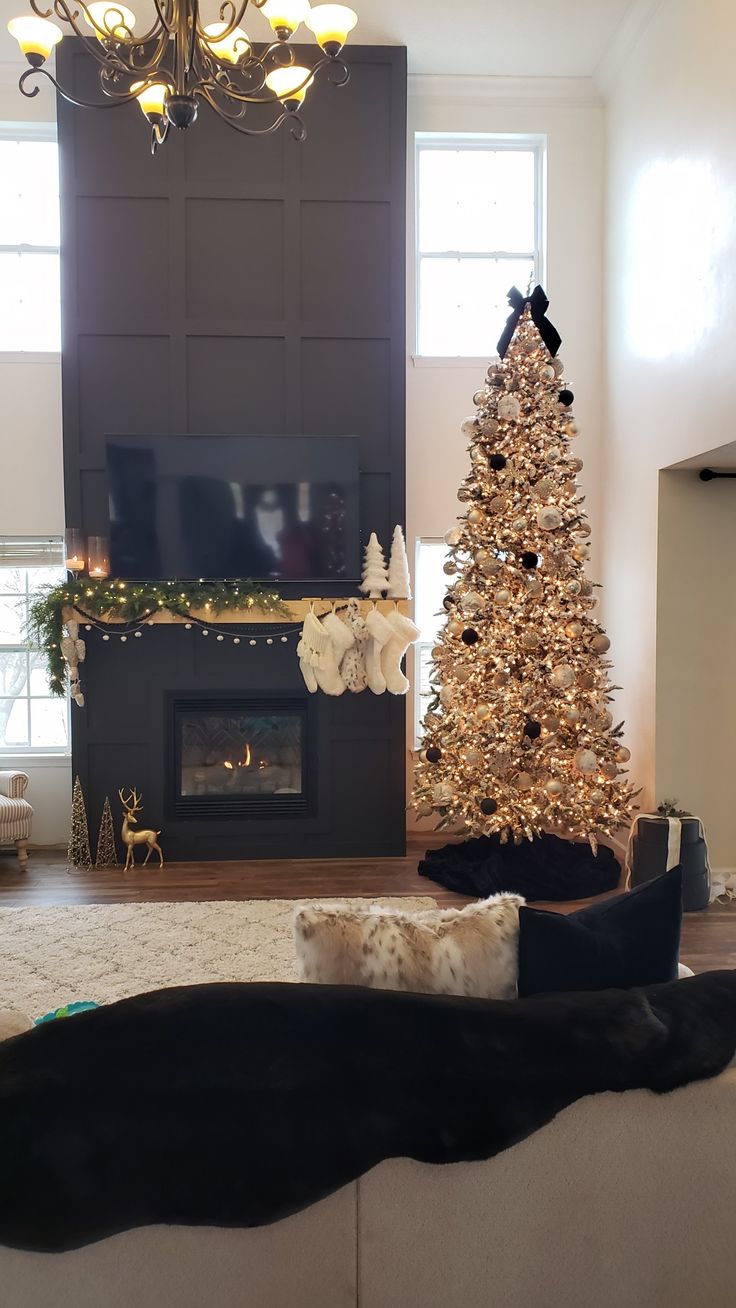 a living room with a christmas tree in the corner and a fire place next to it