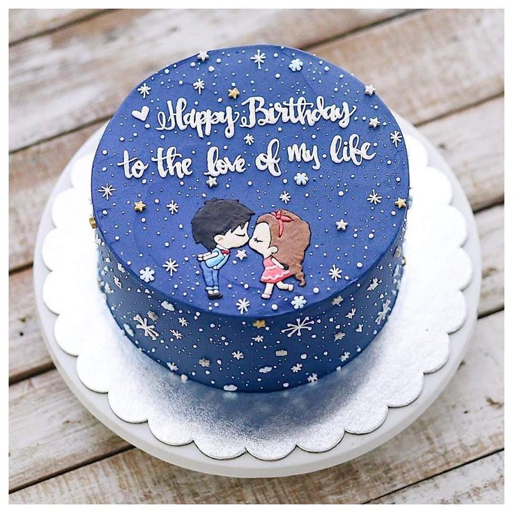 a blue birthday cake decorated with cartoon characters on the top and writing happy birthday to the love of my life