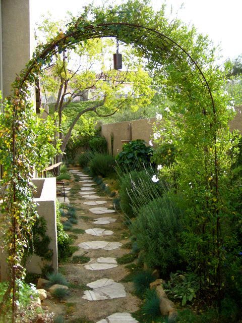 a stone path in the middle of a garden