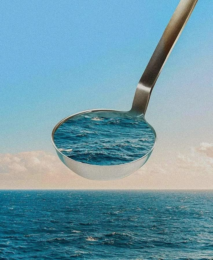 a spoon floating in the air over water