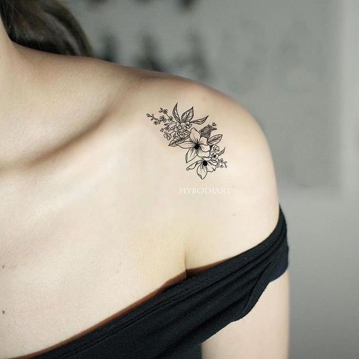 a woman with a flower tattoo on her shoulder