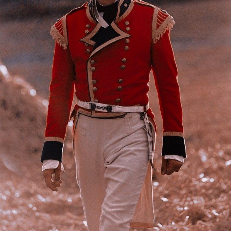 a man in uniform walking down the street