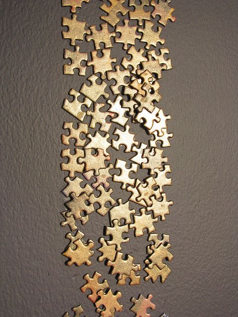 a group of puzzle pieces sitting on top of a table next to each other in front of a wall