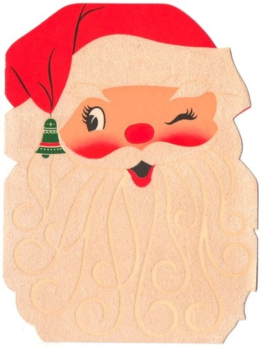 a paper cut out of santa claus with a christmas tree on his nose and hat