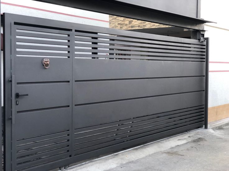 a large metal gate on the side of a building