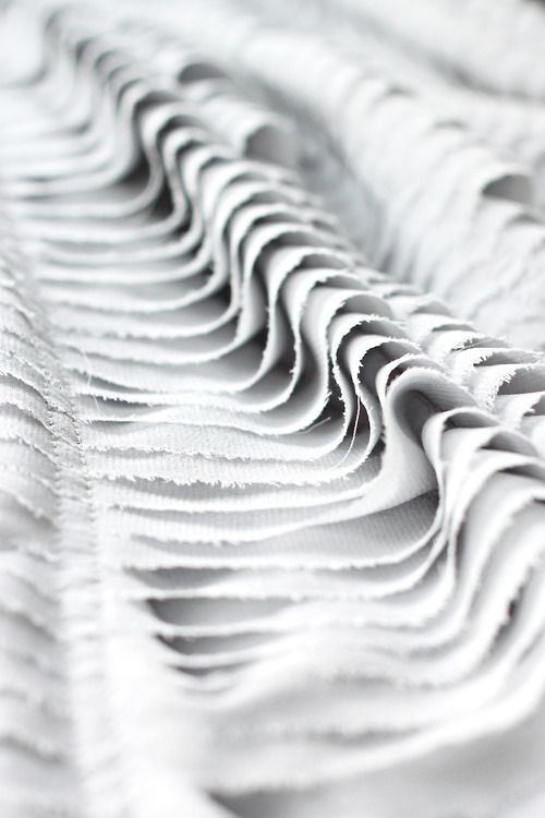 an abstract photo of white fabric with wavy lines