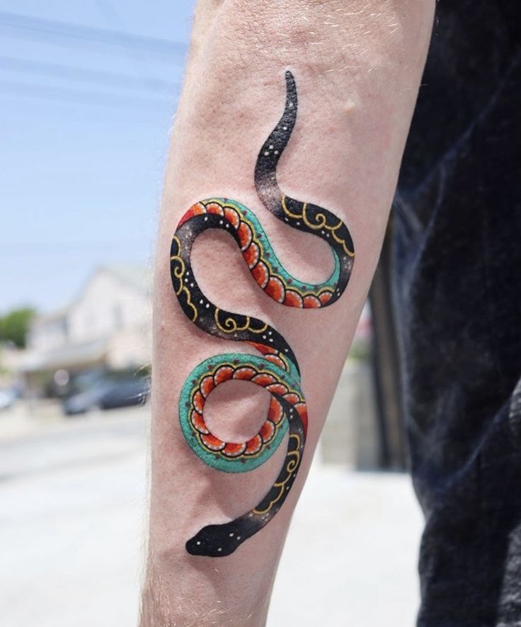 a man with a tattoo on his arm has a snake tattooed on it's leg