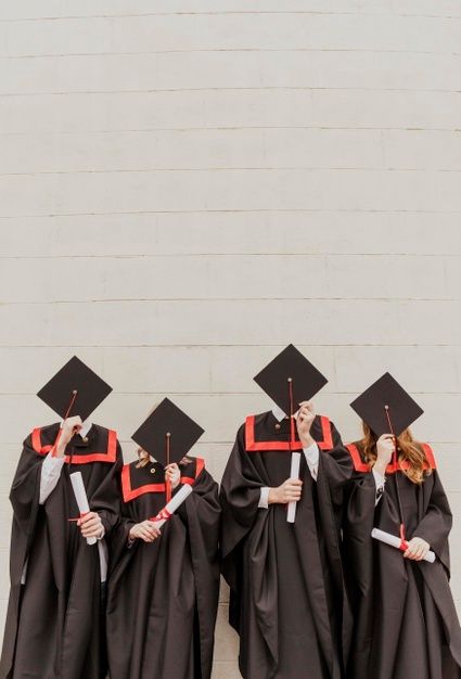 four graduates in graduation gowns and caps