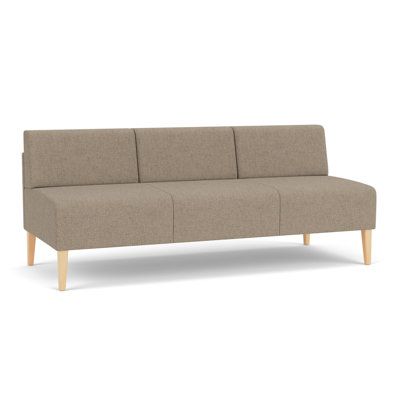 a beige couch with wooden legs on a white background