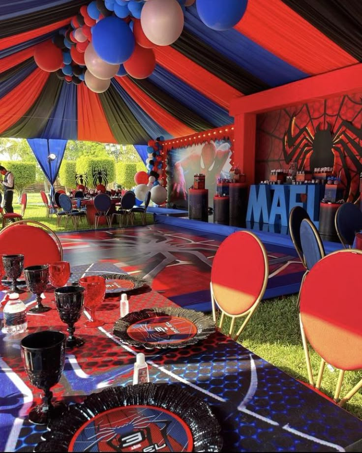 a party tent with red, white and blue decorations on the tables set up for an event