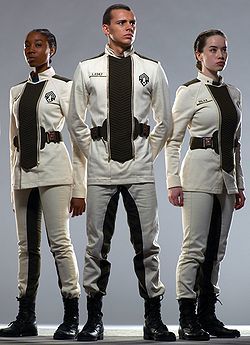 three models in white outfits stand next to each other with their hands on their hips