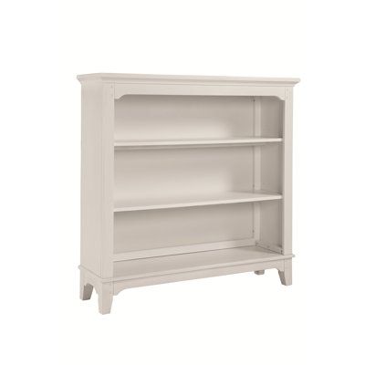 a white book shelf with two shelves on each side