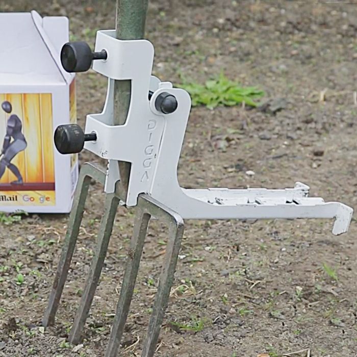 a pair of garden shears sitting on the ground next to a box