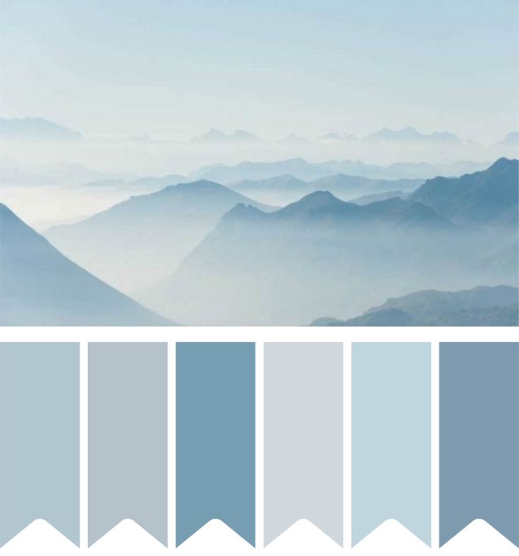 the mountains are covered in fog and blue hues