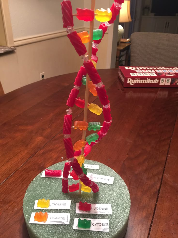 a wooden table topped with lots of different colored pieces of paper on top of it