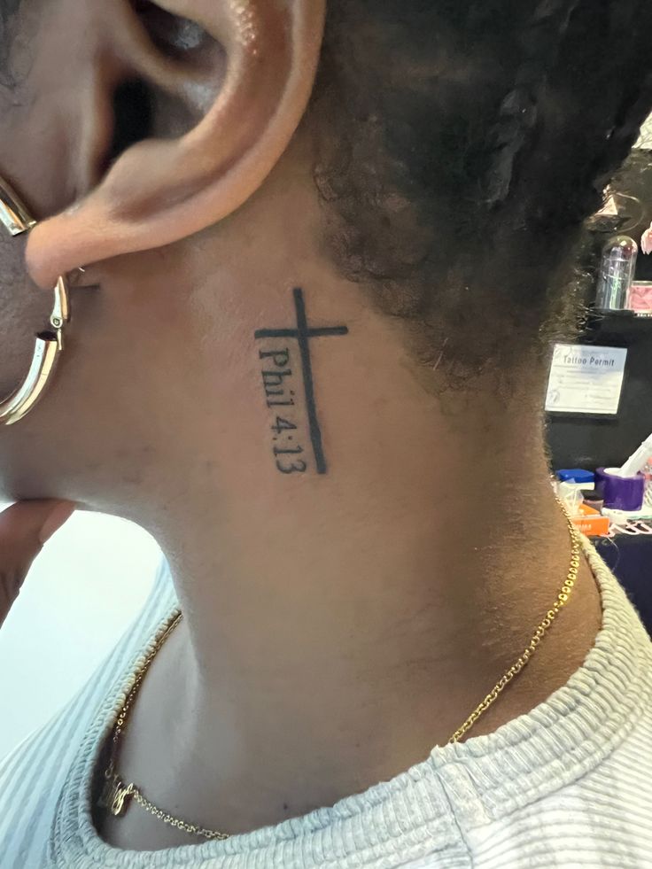 a person with a cross tattoo on their neck