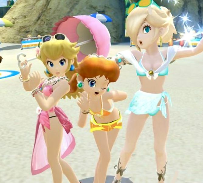 three women in bikinis standing on the beach