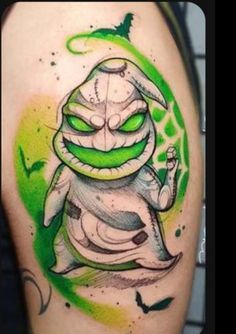 a green and white tattoo with a cartoon character on it's arm, in the shape of a snake