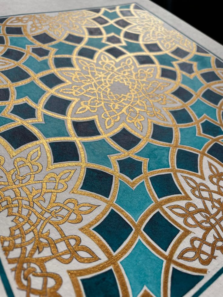 a blue and gold rug with intricate designs on it