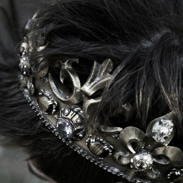 black and white photograph of a woman's head wearing a hair comb with flowers on it