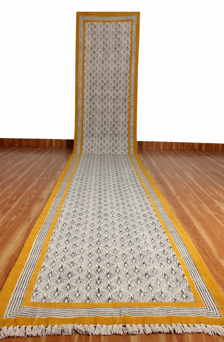 a white and yellow area rug on the floor