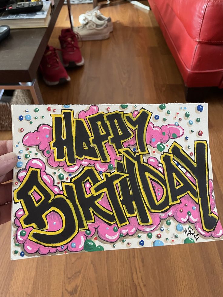 someone holding up a birthday card with the words happy birthday on it