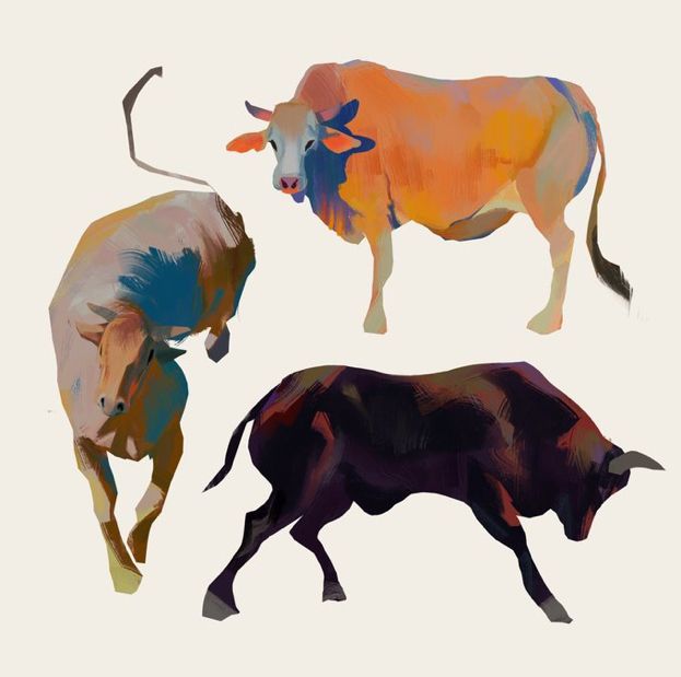 three different colored cows standing next to each other