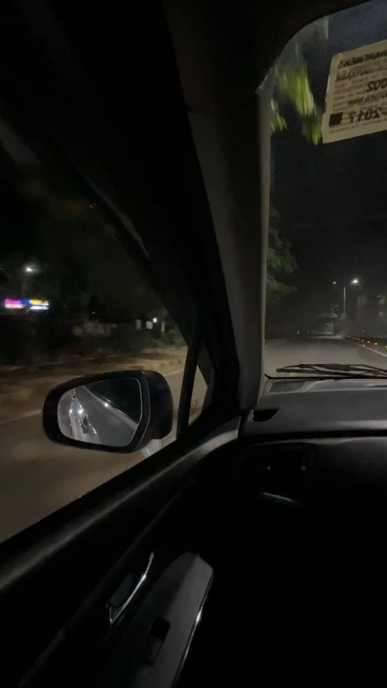 the dashboard of a car at night time with no one in it's seat