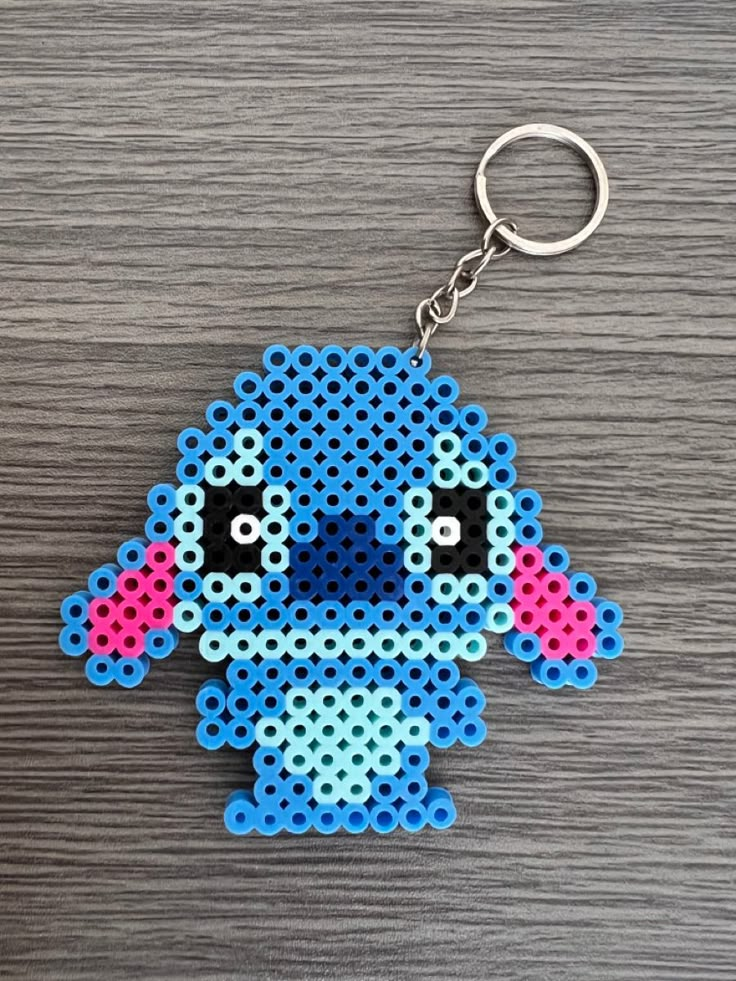 a blue and pink bead stitched keychain with an elephant on it