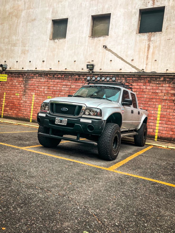 a truck parked in a parking lot next to a building