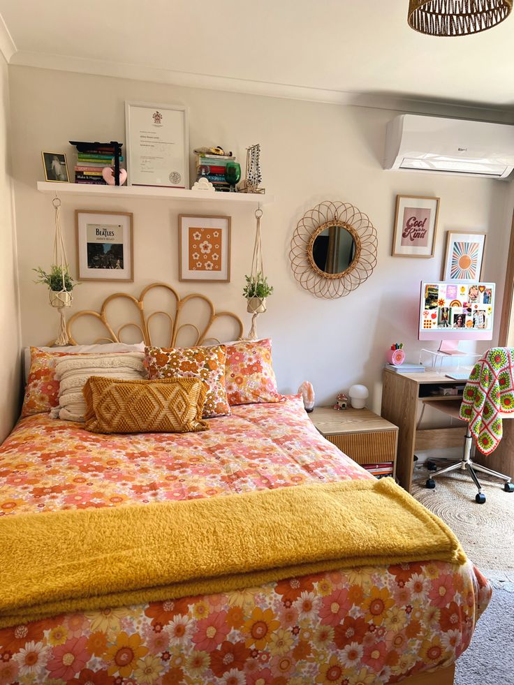 a bed room with a neatly made bed and some pictures on the wall above it