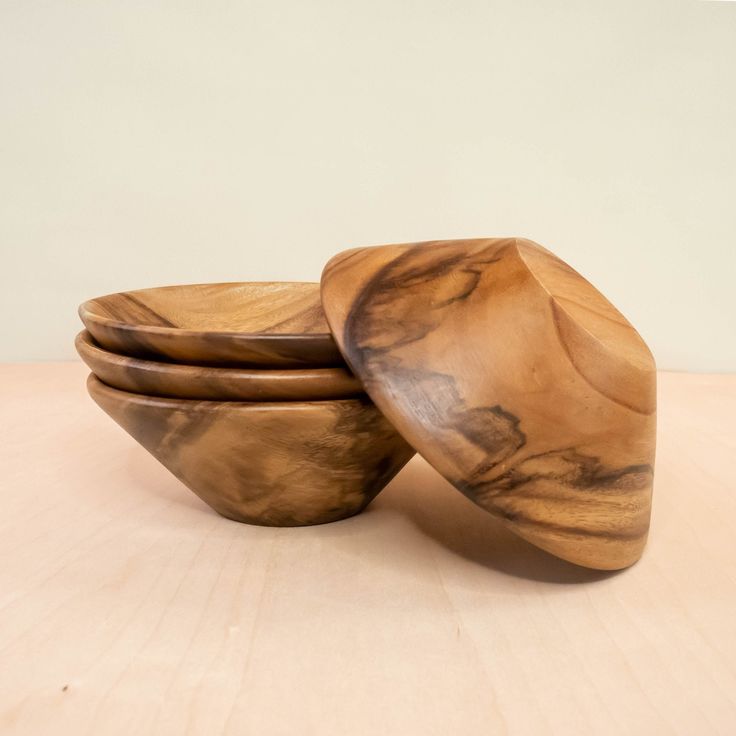 three wooden bowls stacked on top of each other