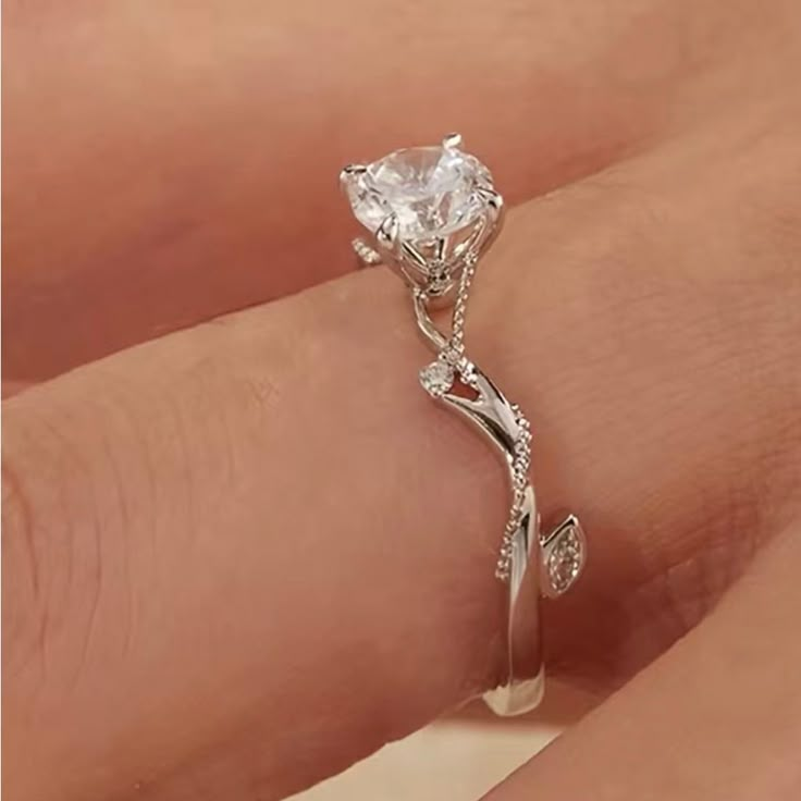 a woman's hand with a diamond ring on it