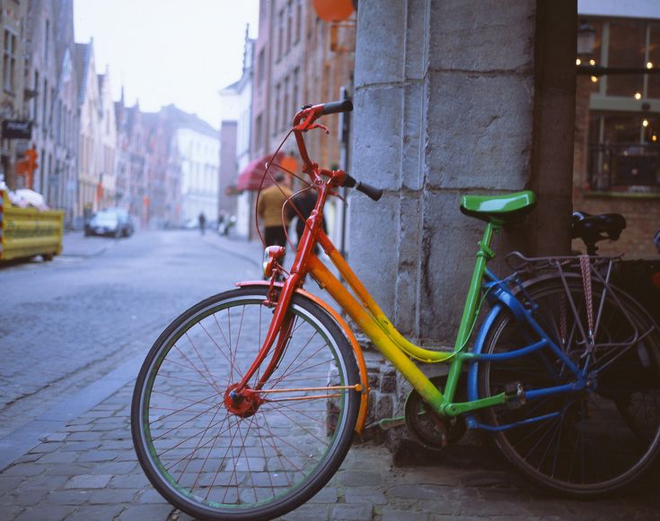 a colorful bike parked on the side of a street