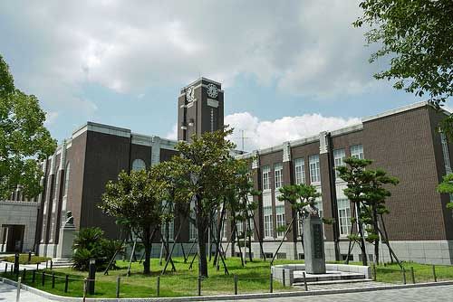 a large building with a clock tower in the middle of it's front yard