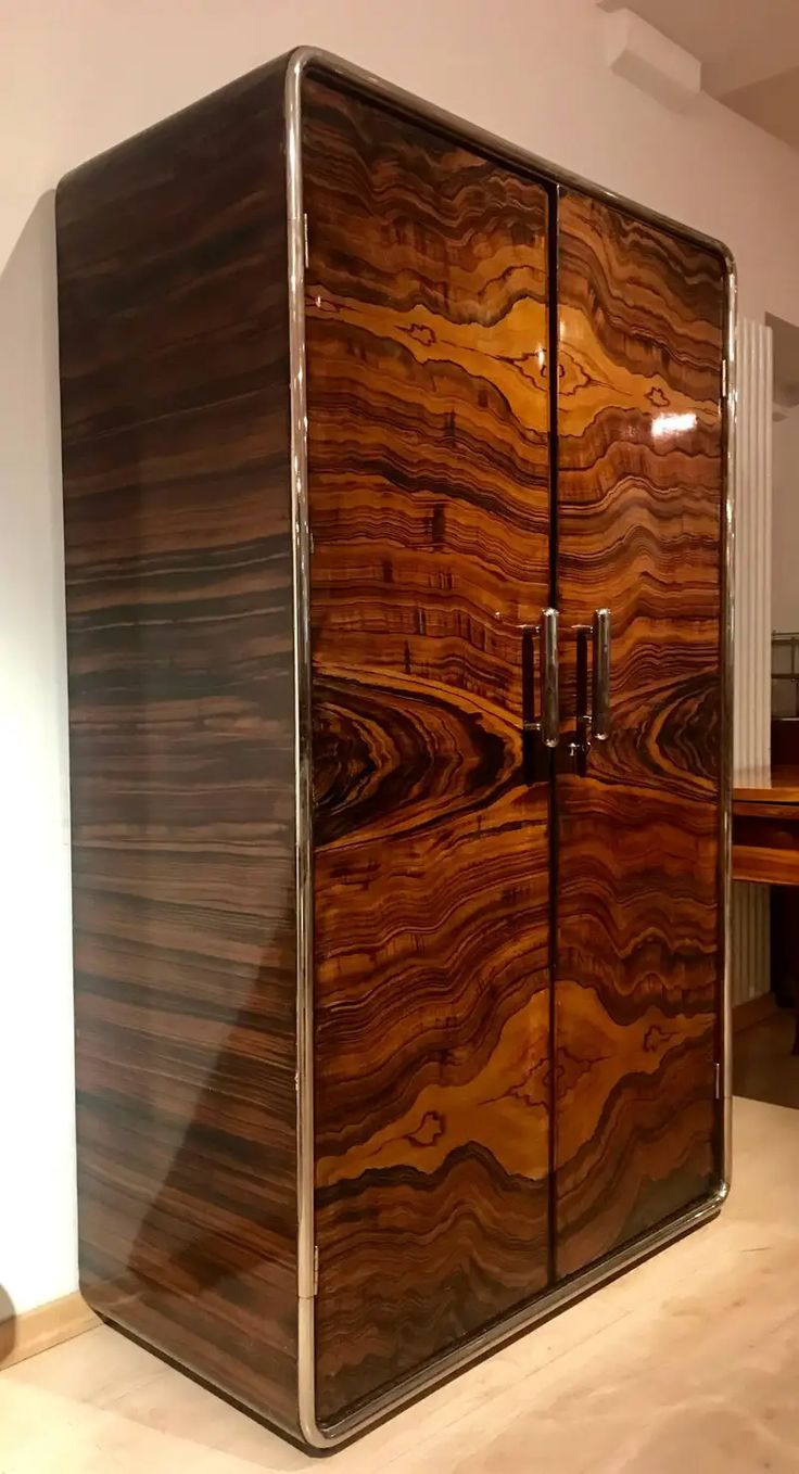 a large wooden cabinet sitting on top of a hard wood floor