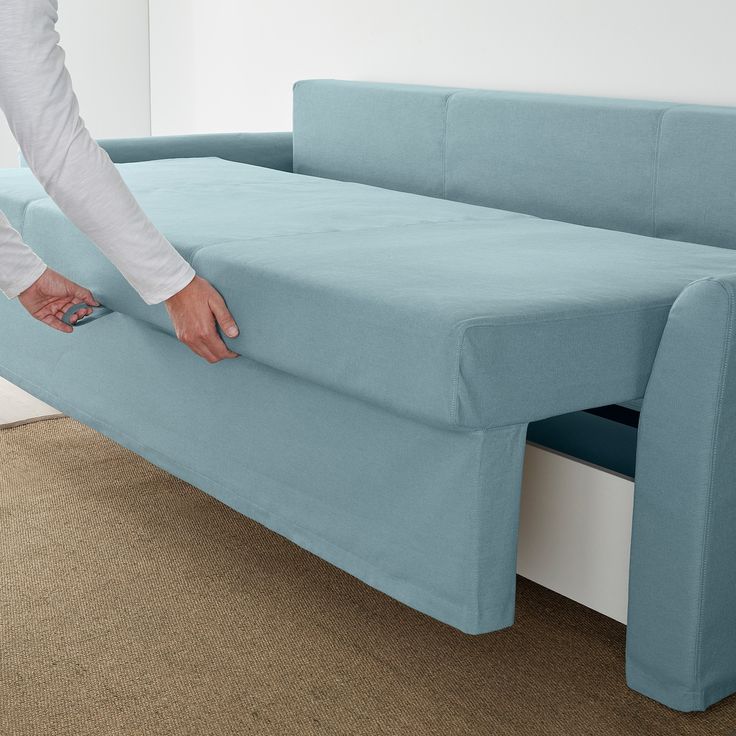 a person is pulling out the back end of a couch