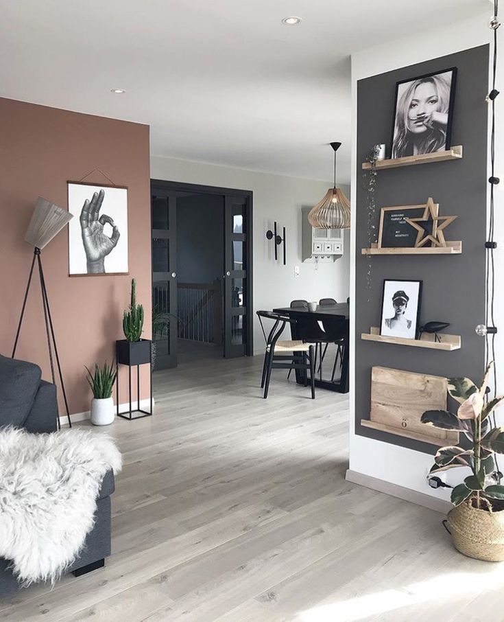 a living room filled with furniture and pictures on the wall next to a dining table