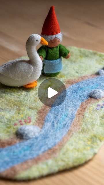 two felt ducks sitting on top of a rug